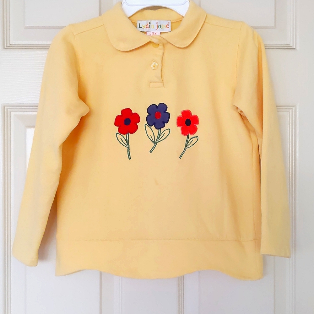 Girl fleece top with embroidered flowers.